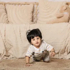 Another angle of this adorable baby exploring the boho set. The wicker furniture adds a lovely rustic touch.