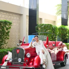 Vintage vibes. Posing with a classic red car in a beautiful all-white embroidered sharara set. This kind of thematic shoot is about creating a mood and transporting the viewer to another era.