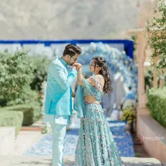 A classic, chivalrous moment as the groom-to-be kisses his partner's hand. This was shot in the beautiful grounds of a Pushkar palace, adding a touch of royal elegance to their pre-wedding story.