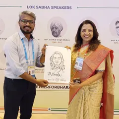 Presenting a caricature to Dr. Manisha Kayande at the NLC. It was a wonderful experience meeting and drawing legislators from across the country.