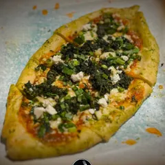 My Turkish Pide is a fantastic alternative to traditional pizza. This boat shaped flatbread has a crispy crust and a soft interior, topped with fresh herbs, cheese, and greens for a light yet flavourful option.