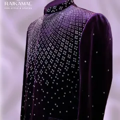 A side profile of the purple velvet Jodhpuri, highlighting the shimmer of the embellishments and the luxurious texture of the fabric.