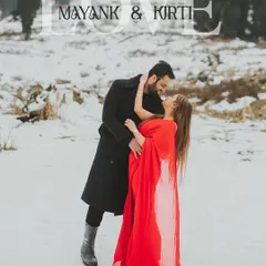 A romantic portrait from a pre-wedding shoot in the snow-covered hills of Kashmir. The couple's embrace, with the bride in a vibrant red gown, creates a powerful, cinematic image that highlights my expertise in destination photography.