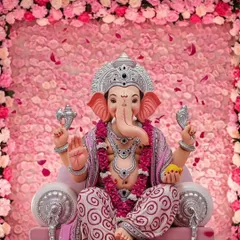 This pastel pink rose decor offers a soft and beautiful welcome for Ganpati. The full floral frame and falling petals create a picture-perfect, gentle setting.