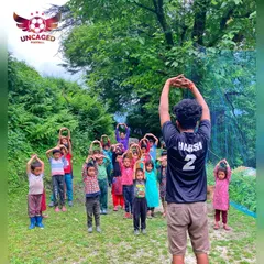 Unity from the very start. This photo shows me leading the children in a group stretching exercise. Performing activities in unison like this helps build discipline and a sense of being part of a single team.