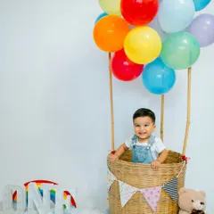 Let's celebrate big milestones with a touch of whimsy. This hot air balloon theme for a first birthday shoot adds a pop of color and imagination, creating a magical memory for your little one's special day.