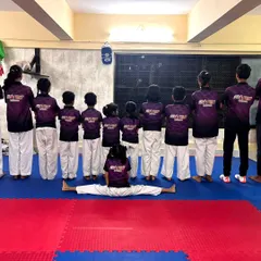 We are a team, front and back. Our students show their unity and flexibility, with one member holding a perfect center split.