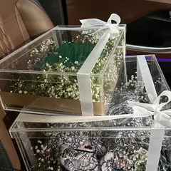 Your bridal trousseau deserves a special welcome. We design exquisite trousseau packaging, like these elegant clear acrylic boxes filled with baby's breath, to make unboxing your precious outfits a memorable moment.