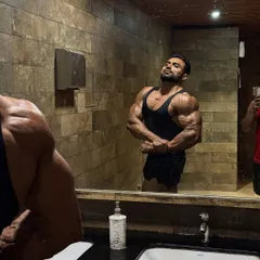 It's not full dry condition, but the work is showing. Posing in the mirror to check progress.