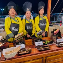 The team at the Japanese food station, offering a selection of sushi including Chicken Uramaki, Fish Californian Roll, and Prawns Tempura.