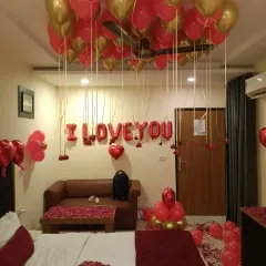 Another perspective of the romantic room decor, showing the seating area also decorated with rose petals.