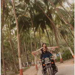 A classic romantic bike ride through a lane of towering palm trees in Lakshadweep. This shot captures a sense of freedom, adventure, and cinematic romance.