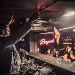 In the zone, with the crowd right there with me. This is the core of what I do: reading the room and dropping the perfect track to keep the energy soaring all night long. A packed club night is my playground.