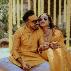 A cool and happy couple posing in sunglasses during their Haldi ceremony. This photo shows their fun-loving personalities and the relaxed vibe of the celebration.