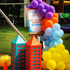 A cheerful welcome sign for Aryan's birthday party, framed by a colorful balloon arch. I paired it with my custom-built cardboard skyscrapers to immediately establish the fun, city-superhero theme for arriving guests.