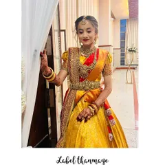 I designed this traditional South Indian half-saree lehenga for a puberty ceremony. The rich yellow and red silk fabric is perfect for such a grand occasion.