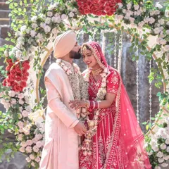 A tender kiss on the forehead during the Varmala ceremony, a quiet moment of affection amidst the grand celebration.