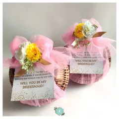 Two beautiful bridesmaid proposal baskets, wrapped and ready to go. Each one includes a personal note asking that all-important question.
