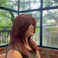 A side profile of the butterfly cut, showing how the layers are cut to create a flattering, face-framing effect.
