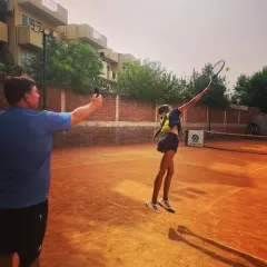 Here I am conducting a serve speed test with one of my junior players. We analyze the data to adjust power percentages, helping them achieve the perfect balance of speed and accuracy.