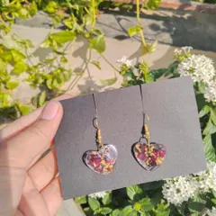 A pair of heart shaped earrings made with real preserved rose petals and gold flakes. Each pair is unique because they are made from real flowers.
