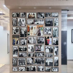 For Kiran Gems, a global leader in the diamond industry, we were entrusted to create a legacy wall from 45 of their most treasured photographs. We crafted a stunning visual timeline using premium metal frames, turning milestone moments with national leaders and historic achievements into a powerful corporate art installation.