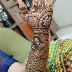 A close-up of a design with beautiful lotus and other floral motifs. The shading technique makes the flowers look like they are blooming on the skin.