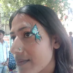 A close-up of one of my favorite butterfly designs. The vibrant teal glitter catches the light beautifully, and the fine black and white details make the design pop. I use only cosmetic-grade, skin-safe glitter for all my face painting.