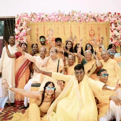 A fun-filled family portrait from a Haldi ceremony. This shot captures the playful and celebratory spirit of the event, with everyone dressed in yellow and posing with joy.