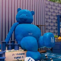 A giant, custom-made blue teddy bear, monogrammed with the birthday boy's initials, makes for an unforgettable statement piece. This bespoke prop is a client favorite for first birthdays and baby showers.