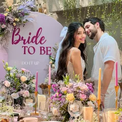 A 'Bride to Be' celebration, designed as a chic and floral-forward bridal shower. The tablescape is filled with flowers, and the custom backdrop creates the perfect photo opportunity for the bride.