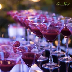 Adding a touch of style and luxury to the beverage service. These elegant martini glasses are filled with a deep red Cranberry Sorbet, a sophisticated and refreshing treat for guests to enjoy.