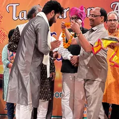 Being felicitated with a traditional garland at the award ceremony.
