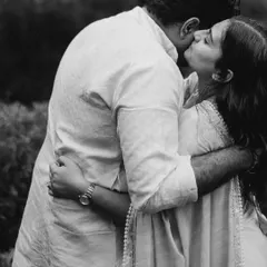 A tender kiss in a quiet moment. The black and white tones add a sense of nostalgia and romance, making this simple gesture feel profound.