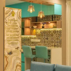 A close-up of the breakfast counter and its connection to the living space. The design includes a custom onyx-style panel with engraved scriptures, adding a personal and spiritual touch to the home's entrance.