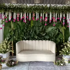 A full view of the beautiful floral stage I designed for an engagement. The natural green backdrop with hanging flowers creates a fresh and elegant setting.