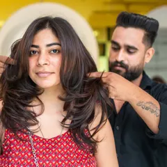 Our stylist adding the finishing touches to a beautiful layered haircut. We focus on the details to ensure your cut is perfect from every angle.