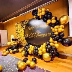 A side angle of the elegant black and gold setup, highlighting the custom calligraphy on the backdrop.