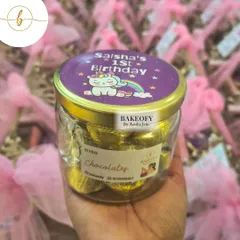 A jar of my homemade chocolates, wrapped in gold foil and sealed with a custom-designed lid for a little girl's first birthday celebration.