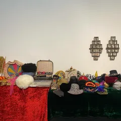 A table laden with props, hats, and accessories for the 'Pop Up Studio' at the 'Southern Stars' show. This interactive component allowed visitors to play and create their own cinematic personas.