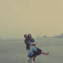 A couple joyfully embraces the Goan monsoon, dancing barefoot on the wet sand. We believe the best moments are unscripted, and our rainy pre-wedding shoots are perfect for capturing that spontaneous, carefree love.