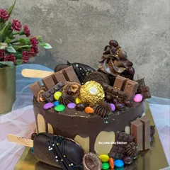This is my ultimate Chocolate Heaven cake, fully loaded with gems, KitKat, Ferrero Rocher, and even chocolate cakesicles for an extravagant celebration.