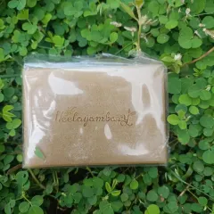 A close-up of the Multani Mitti soap bar, showing the Neelayambary logo embossed on it. This natural clay soap is a traditional remedy for oily and acne-prone skin.