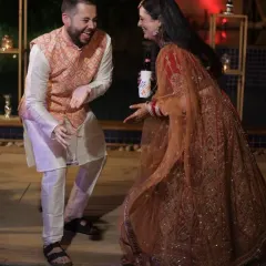 A candid shot of a guest and the bride sharing a playful dance moment. It's these unscripted interactions that add so much life to a wedding story.