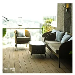 This balcony was transformed with warm WPC decking and comfortable all-weather wicker furniture. The space now functions as an elevated outdoor lounge with expansive city views, complete with modern wall lighting for evening ambiance.