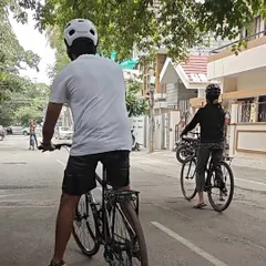 A view from behind shows our students practicing on the road. Everyone wears a helmet, which we provide, and we ensure the environment is safe for learning. This is the first step towards a lifetime of cycling adventures.