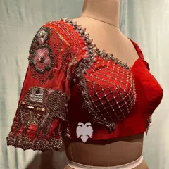 A stunning red silk corset blouse with Paithani artistry, featuring embroidered elephants and floral motifs for a regal yet modern look.