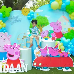 A fun-filled Peppa Pig party in an outdoor setting. We created a vibrant scene with character cutouts, a custom backdrop of Peppa's house, and a large light-up number '2' for the birthday boy's special day.