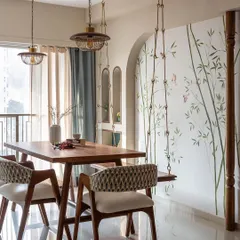 A hand-painted bamboo mural brings a sense of tranquility to this dining area. The delicate branches and small sparrows create a light, airy feel, perfectly complementing the wooden swing and turning the corner into a peaceful retreat.