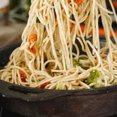 A close-up of our Farmer's Style Spaghetti, tossed with fresh broccoli and sun-dried tomatoes. It's a simple, rustic dish that's packed with flavor and goodness.